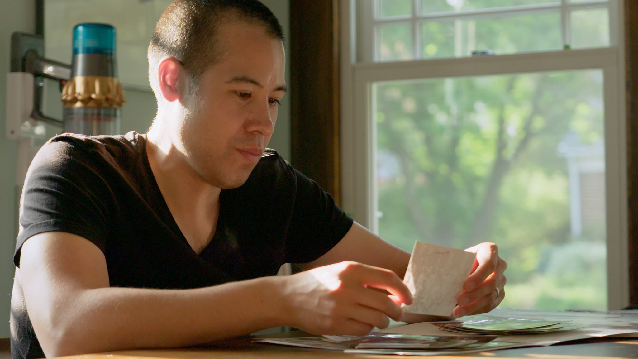 Dr. Nathaniel Chin looks at family photos.