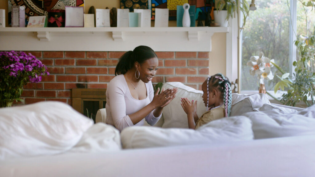 Cassandra Trimnell, founder of Sickle Cell 101, plays with her daughter at home.