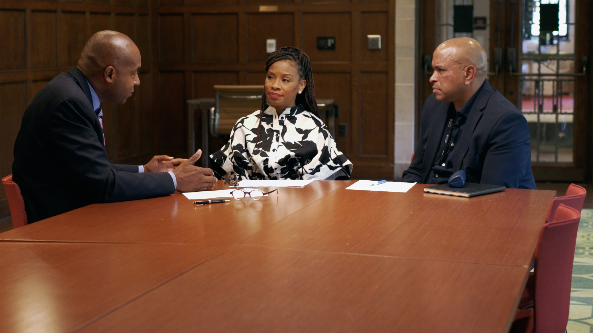 Drs. Selwyn Rogers, Sonya Mathies Dinizulu, and Franklin Cosey-Gay sit at a table and discuss trauma-informed care.